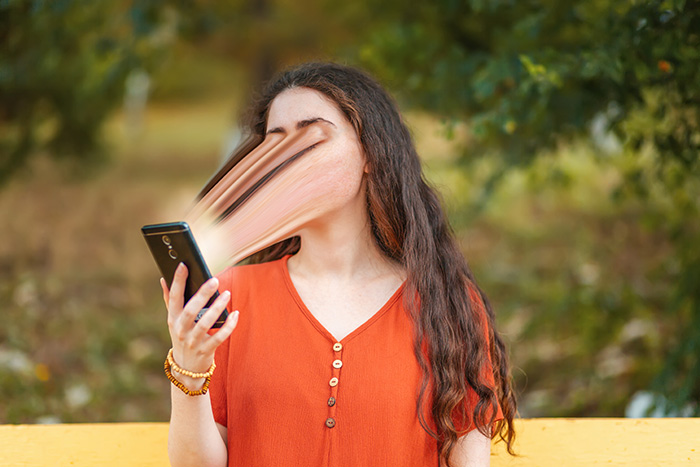 Portrait,Of,A,Young,Long-haired,Woman,Using,A,Smartphone.,The